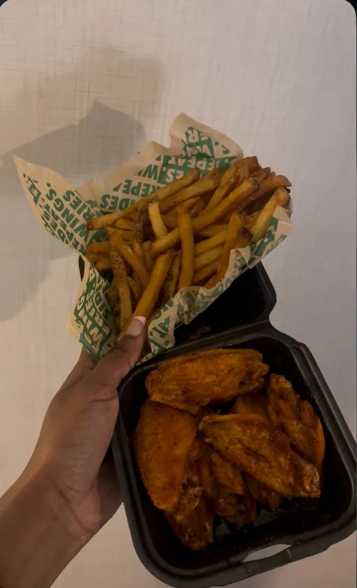 Wingstop storefront outside and inside view at 7107 NW Barry Rd. in Kansas City, Missouri