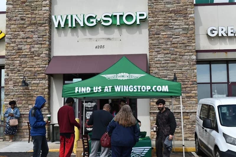 Wingstop storefront outside and inside view at 4205 W Wendover Ave in Greensboro, North Carolina