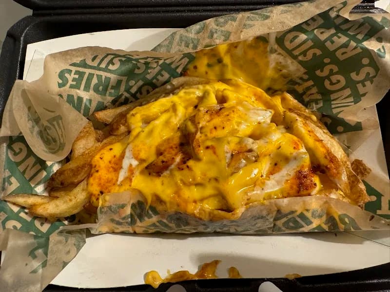 Wingstop storefront outside and inside view at 233 Avalon Ave in Muscle Shoals, Alabama