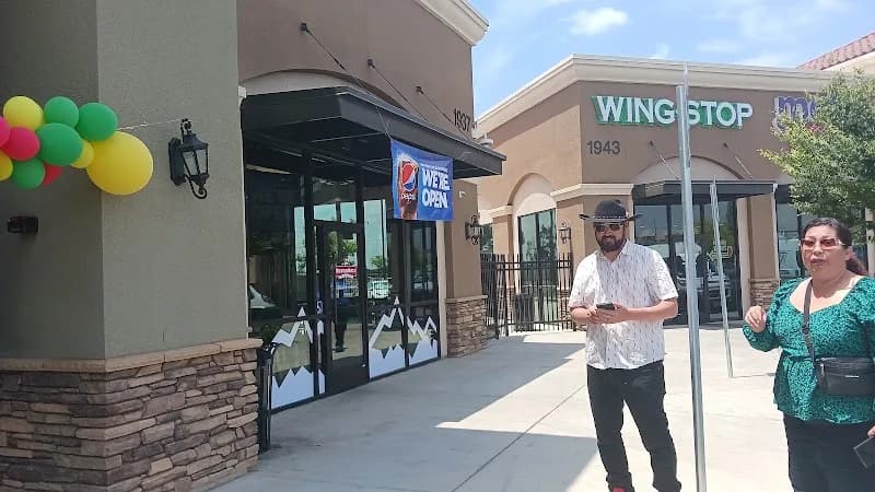 Wingstop storefront outside and inside view at 1943 W. Clinton Ave in Fresno, California