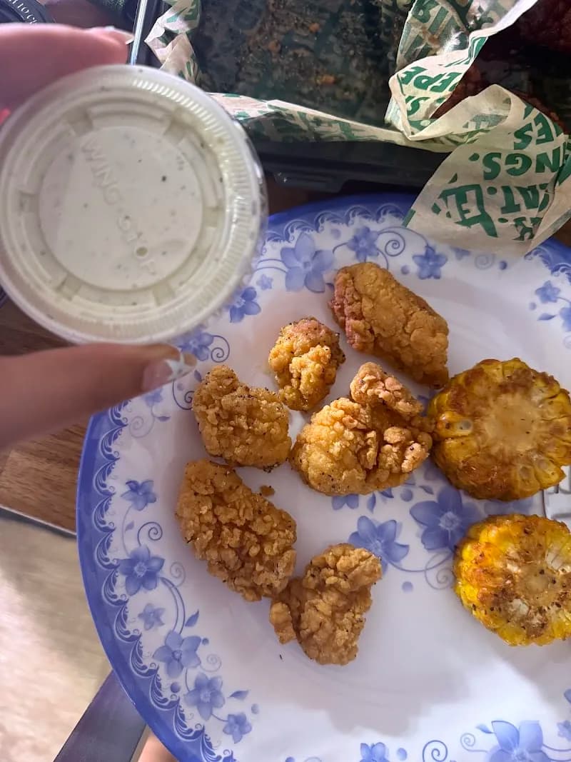 Wingstop storefront outside and inside view at 6918 Warner Ave in Huntington Beach, California