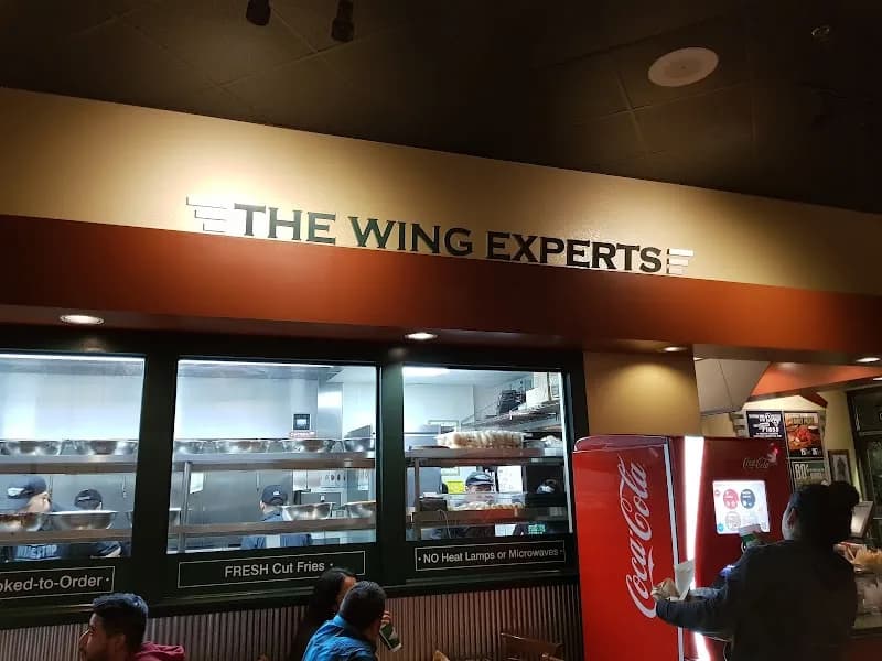 Wingstop storefront outside and inside view at 5857 S Central Ave Ste 170 in Los Angeles, California