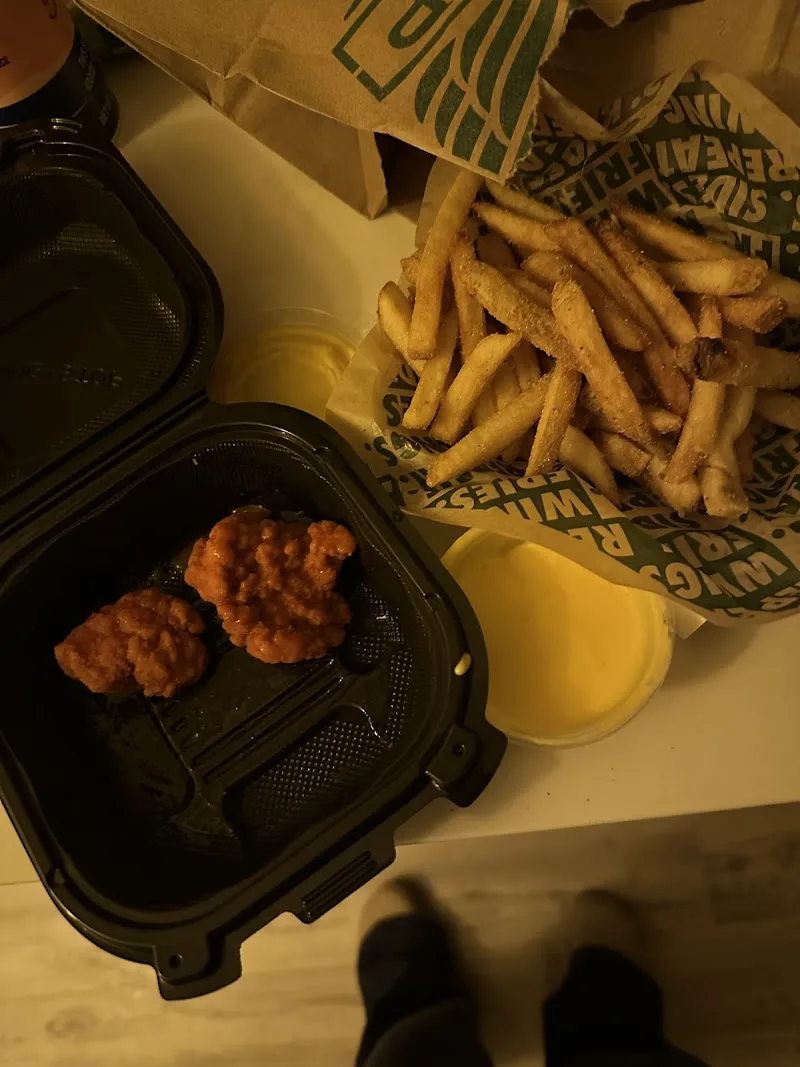 Wingstop storefront outside and inside view at 58132 Twentynine Palms Hwy in Yucca Valley, California