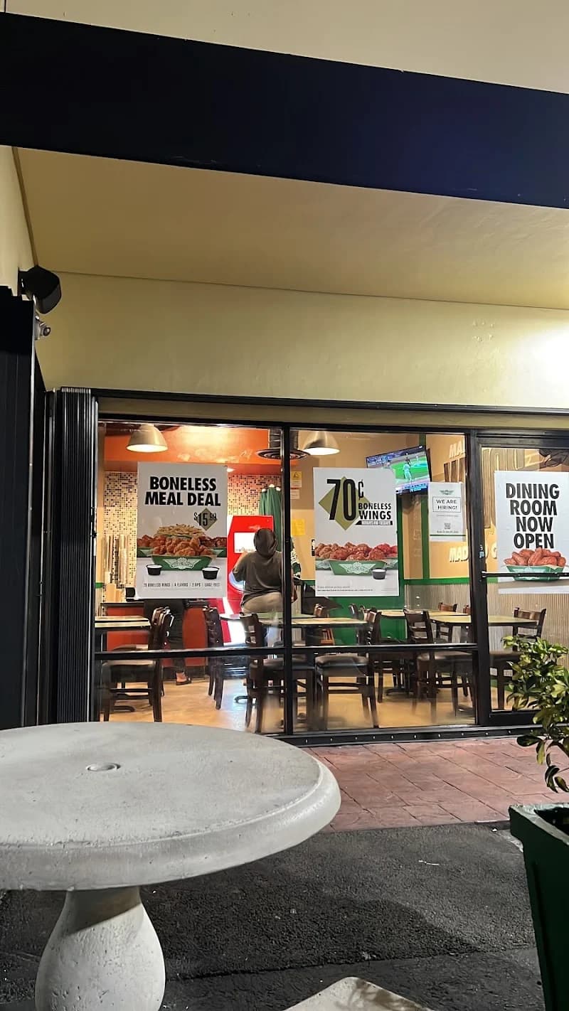Wingstop storefront outside and inside view at 927 NE 125th St. in North Miami, Florida
