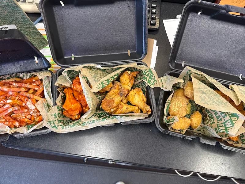 Wingstop storefront outside and inside view at 3120 Manawa Centre in Council Bluffs, Iowa