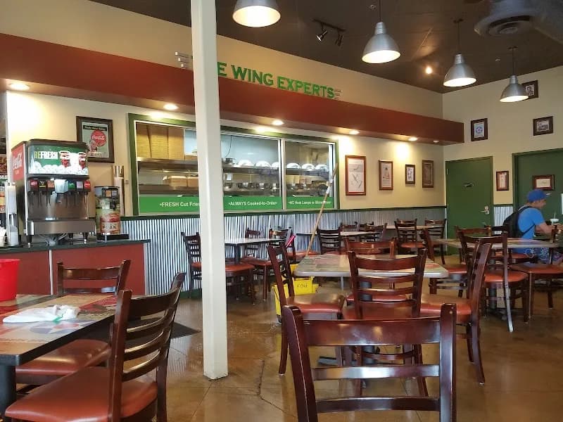 Wingstop storefront outside and inside view at 3057 N Pulaski Rd in Chicago, Illinois