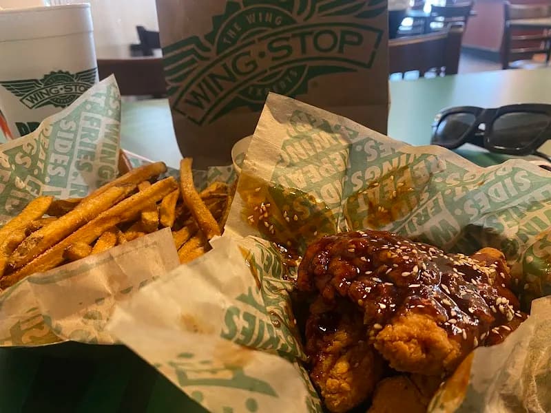 Wingstop storefront outside and inside view at 12 E Harrison St in Chicago, Illinois
