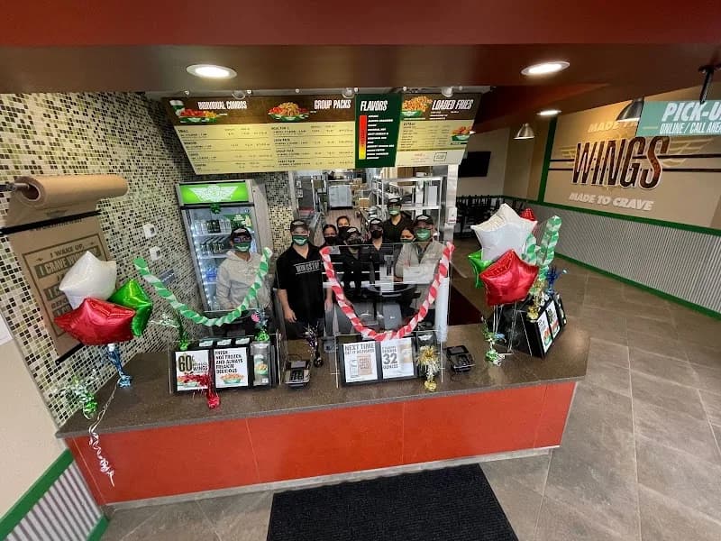 Wingstop storefront outside and inside view at 7801 Archer Ave in Justice, Illinois