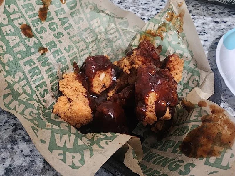 Wingstop storefront outside and inside view at 4568-600 Elkhart Rd in Elkhart, Indiana