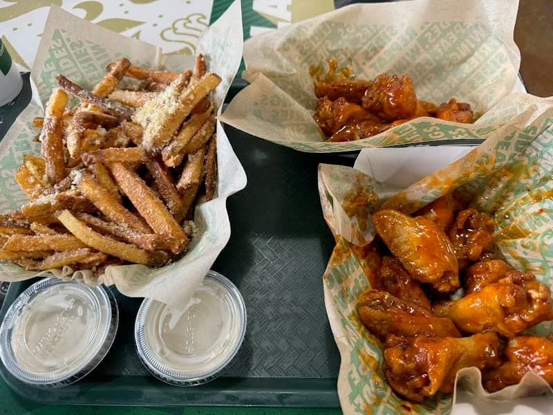 Wingstop storefront outside and inside view at 7326 Pendleton Pike in Indianapolis, Indiana
